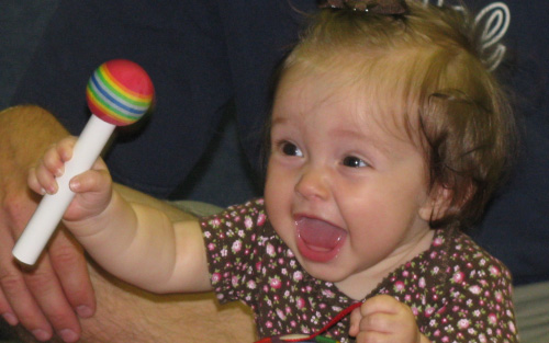 baby playing with rattle